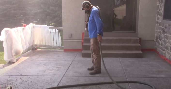 Sand blasting to remove concrete sealer