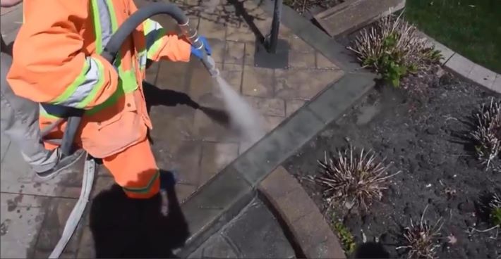 Wet media blasting to remove concrete sealer