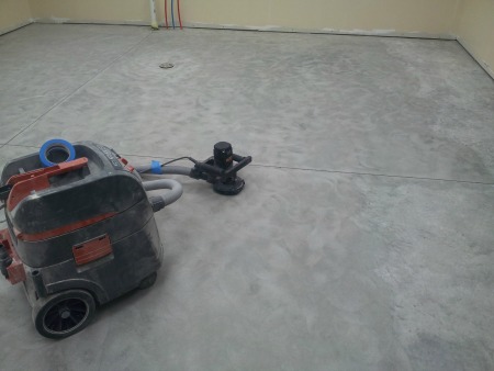 Hand held floor grinder to prep concrete for an epoxy coating